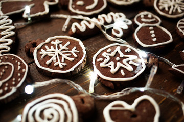 Traditional homemade Christmas ginger and chocolate cookies decorated with white sugar painting