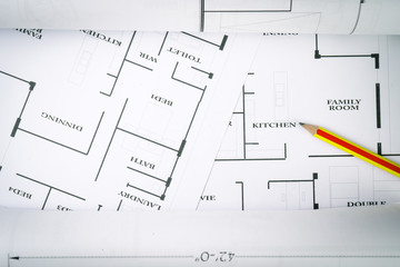 Top view of architect drawing on non identified architectural project with various of tools such as divider pencil eye glassed and small heavy equipment machine toys , toned color or instagram tone.