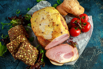 Festive ham served with tomatoes and rustic bread