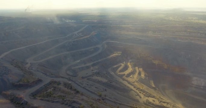 Aerial view of quarry mining of iron ore, metallurgy production, top view, at sunset time, opencast mining quarry