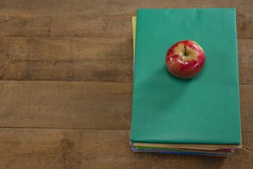 Red apple on book stack