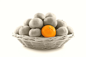 Orange on grayscale of many ripe oranges crop in brown wicker basket isolate on white background.
