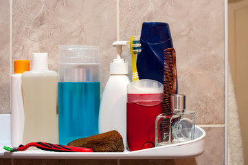Shelf in the bathroom with hygiene products.