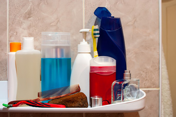 Shelf in the bathroom with hygiene products.