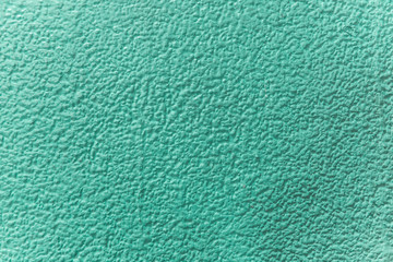 Green texture, close up on rough texture on the wall, abstract background.