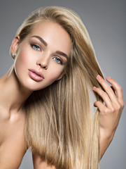 Fototapeta premium Beautiful young woman with long straight hairs