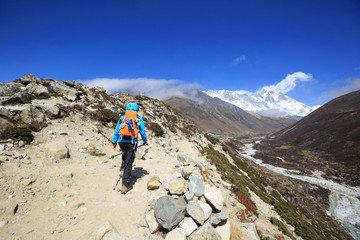 Fototapeta na wymiar young woman backpacker trekking on himalaya mountains,drying socks on the backpack