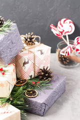 Christmas gifts, new year, holiday, bow, boxes, spruce branches, decorations, selective focus, vertical
