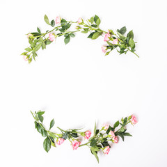 Flowers composition. Frame made of dried rose flowers on white wooden background. Flat lay, top view