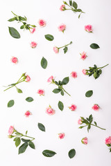 Flowers composition. Frame made of dried rose flowers on white background. Flat lay, top view.