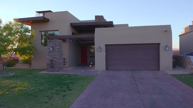 Southwest Style Home Exterior at Sunset. a rising shot of a unique adobe style southwest home during sunset
