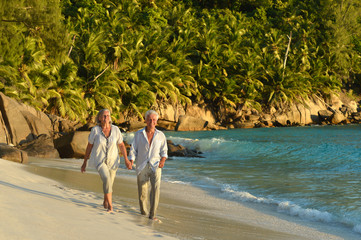 couple walking on  tropical beach