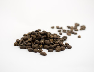 Isolated dark roasted coffee beans on white background