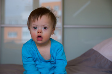 Portrait of cute baby boy with Down syndrome