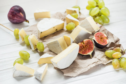 cheese and camembert on a white wooden table