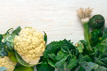 green vegetables on a white wooden board