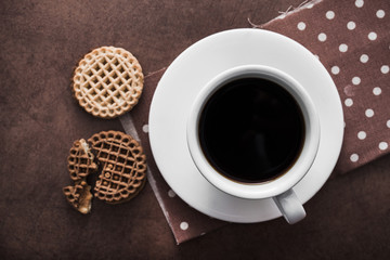 white cup of coffee with chocolate cookies
