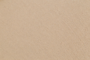 Fototapeta na wymiar Close-up of smooth sand at a beach texture background.
