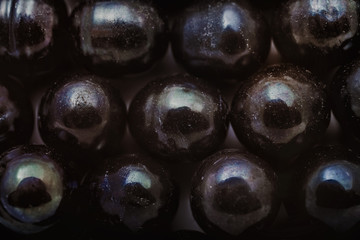 Background with shiny beads of black pearls