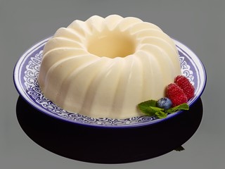 French food : cream-mousse cupcake modern european dessert with raspberry 