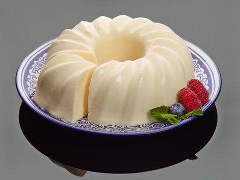French food : cream-mousse cupcake modern european dessert with raspberry and slice