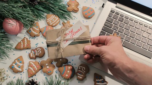 Man teasingly shows the gift. Christmas and New Year holidays and greetings concept, top view