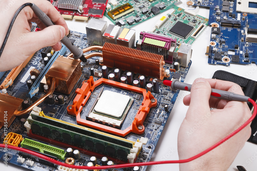 Poster Engineer checking motherboard with multimeter