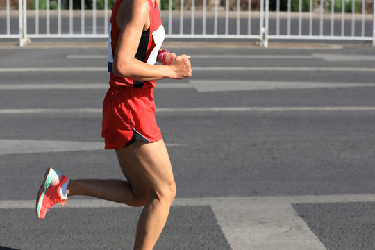 Marathon Runner Running On City Road