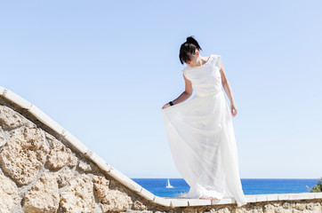 Fototapeta na wymiar Beautiful woman in white dress