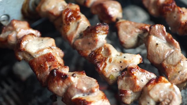 Fragrant kebab is roasted on skewers on the grill rotating