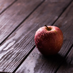 Red apple on wooden table