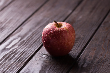 Red apple on wooden table