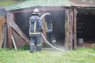 The team of firefighters eliminates the fire in an old building