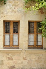 Fototapeta na wymiar Wooden windows on stone house in Pals, Girona, Spain