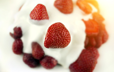 fresh strawberry with cream at sunset.close-up.
