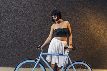 Beautiful woman posing with bicycle 