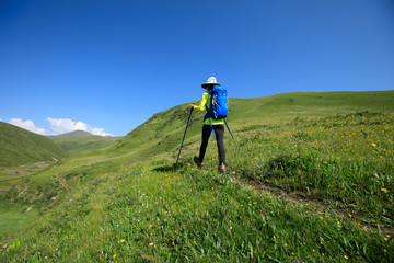Fototapeta premium backpacking woman hiking on prairie mountain trail