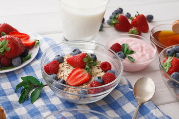 Rich breakfast on white wooden table