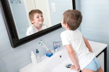 happy smiling little kid in blue bathroom