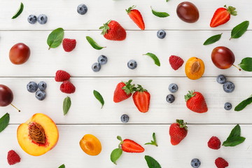Assorted berries on white wooden table top view