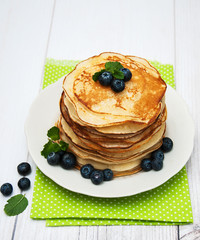 Plate with pancakes and blueberries