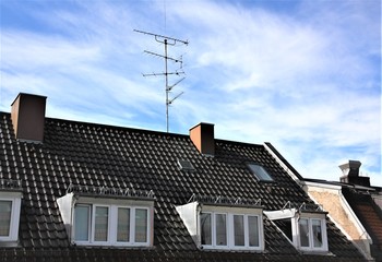 Roof top with chimney, windows and antenna