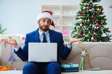 Businessman working at home during christmas