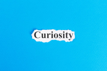 curiosity text on paper. Word curiosity on torn paper. Concept Image