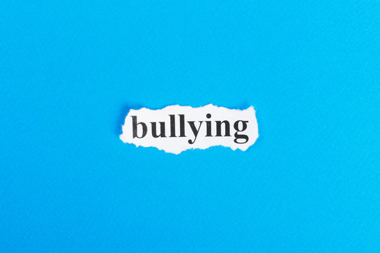 Bullying text on paper. Word Bullying on torn paper. Concept Image