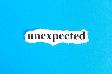 unexpected text on paper. Word unexpected on torn paper. Concept Image