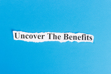 Fototapeta na wymiar Uncover The Benefits text on paper. Word Uncover The Benefits on torn paper. Concept Image