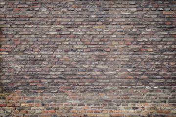 Old and aged red brick wall texture background with vignette.