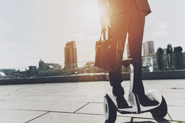 Man in a black suit is moving through the city on monowheel. © Vadym Huzhva