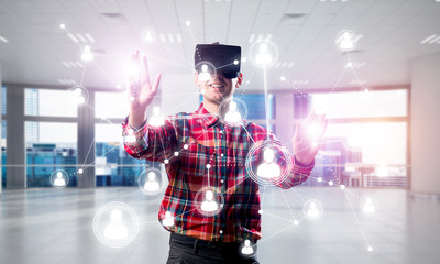 Guy wearing checked shirt and virtual mask reaching hand to touch screen